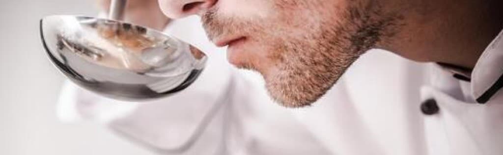 Chef tasting from a spoon